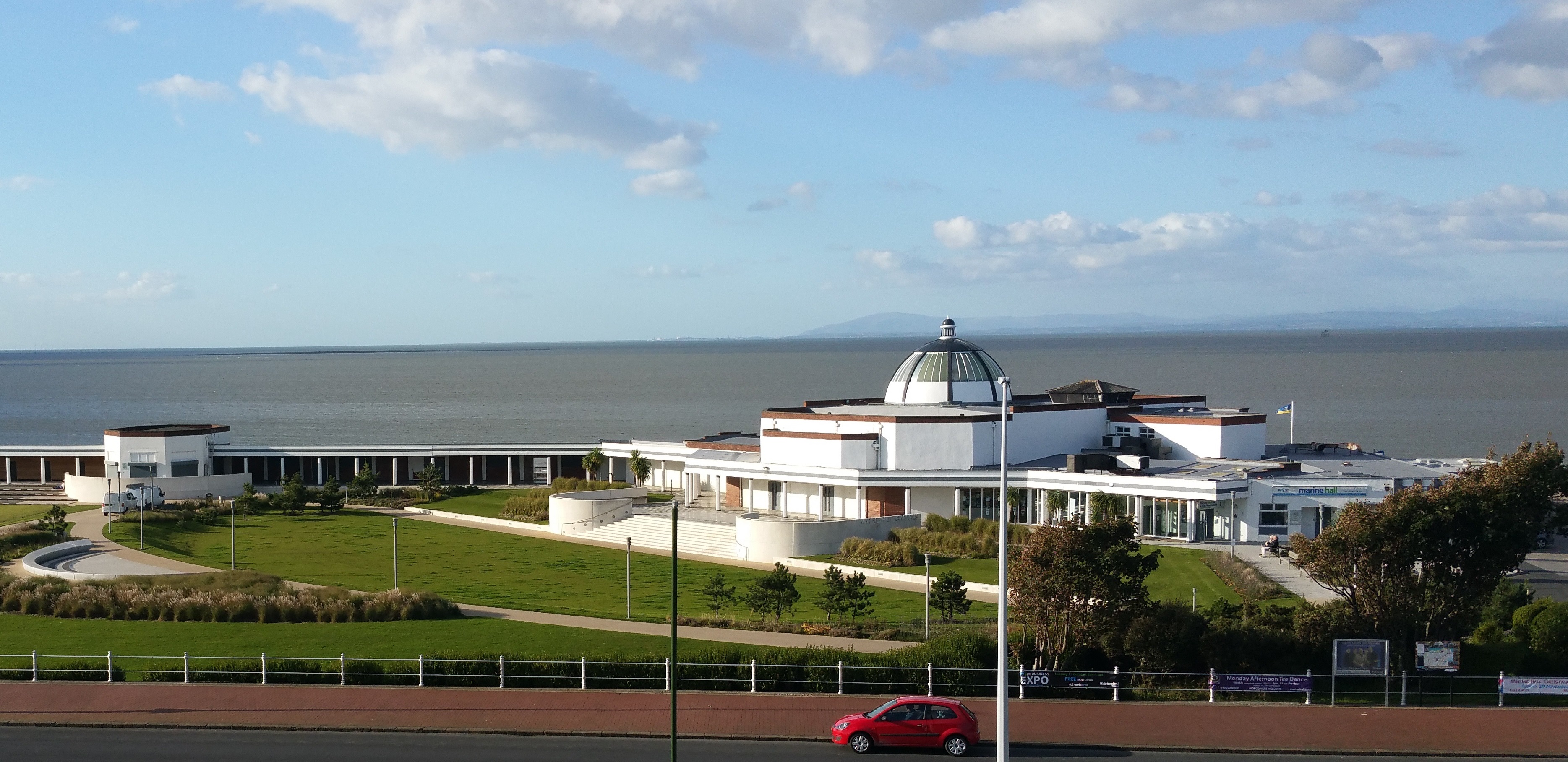 Exterior photo of Marine Hall showing the sky and sea in the background.